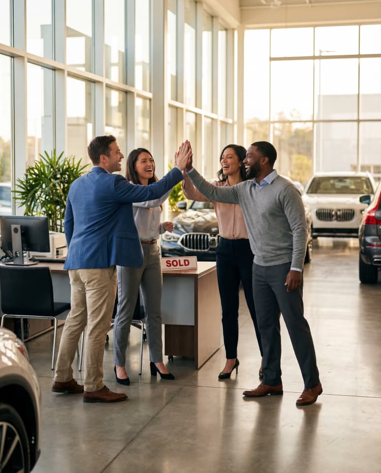 Dealership team celebrating a sale